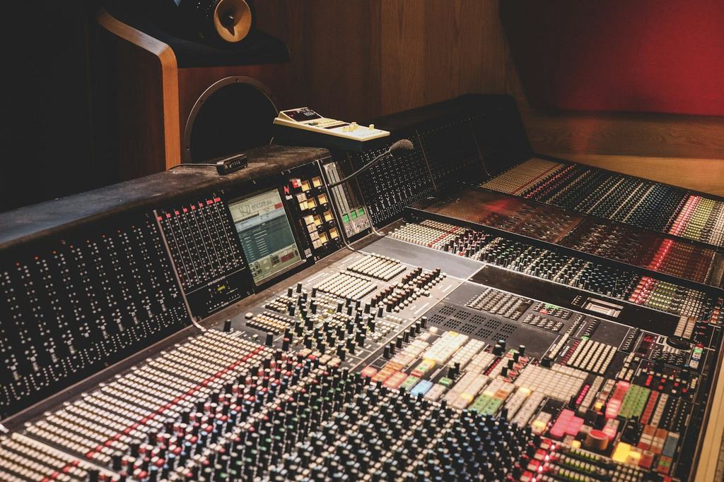 A large analog mixing console in a recording studio
